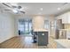 Bright kitchen features an island with bar seating, stainless steel appliances, and sliding glass doors at 117 Macy Cir, Goose Creek, SC 29445