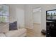 Bright living room with wood floors and a comfortable sectional sofa. Bedroom doorway in background at 117 Macy Cir, Goose Creek, SC 29445