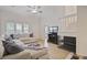 Cozy living room with wood floors, natural light and vaulted ceiling. Stairs to second story in background at 117 Macy Cir, Goose Creek, SC 29445