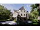 Rear view of an impressive two-story residence featuring a garage and surrounded by lush greenery at 117 Spartina Ct, Kiawah Island, SC 29455