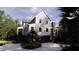 Rear view of a stately two-story house with a garage, complemented by verdant landscaping at 117 Spartina Ct, Kiawah Island, SC 29455