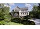 Inviting two-story home with a covered porch and staircase, complemented by green landscaping at 117 Spartina Ct, Kiawah Island, SC 29455