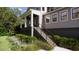 Close-up view of a charming two-story home with a covered porch, steps, and a well-maintained garden at 117 Spartina Ct, Kiawah Island, SC 29455
