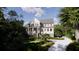 Beautiful two-story house with a welcoming porch and driveway, surrounded by lush trees at 117 Spartina Ct, Kiawah Island, SC 29455