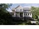 Attractive two-story home with a covered porch, front staircase, and neatly trimmed landscaping at 117 Spartina Ct, Kiawah Island, SC 29455