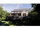 View of the home's screened in back porch and beautiful lawn and landscaping at 117 Spartina Ct, Kiawah Island, SC 29455