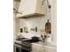 Chef's kitchen features a pot filler, stainless range and custom tile backsplash at 117 Spartina Ct, Kiawah Island, SC 29455