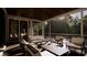Relaxing screened porch features comfortable seating and views of the lush backyard at 117 Spartina Ct, Kiawah Island, SC 29455