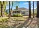 View of home's exterior and backyard through a treed and shaded green space at 1179 Holly Bend Dr, Mount Pleasant, SC 29466