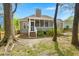 View of home's exterior and backyard through a treed and shaded green space at 1179 Holly Bend Dr, Mount Pleasant, SC 29466