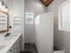 Bright bathroom with double vanity, shiplap walls, a window, and walk-in shower with brick-style tile at 1179 Holly Bend Dr, Mount Pleasant, SC 29466