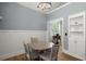 Cozy dining room with modern chandelier, wainscoting detail, and a view into the adjacent living room at 1179 Holly Bend Dr, Mount Pleasant, SC 29466