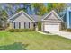 Charming single-story home featuring well-kept lawn, neutral siding, brick accents, and an attached two-car garage at 1179 Holly Bend Dr, Mount Pleasant, SC 29466