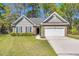 Charming single-story home featuring well-kept lawn, neutral siding, brick accents, and an attached two-car garage at 1179 Holly Bend Dr, Mount Pleasant, SC 29466