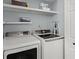 Close up of new, white, front loading washer and dryer with light blue walls in a dedicated laundry area at 1179 Holly Bend Dr, Mount Pleasant, SC 29466