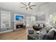 Stylish living room with brick fireplace, comfortable seating, modern lighting, and plank flooring at 1179 Holly Bend Dr, Mount Pleasant, SC 29466