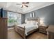 Spacious primary bedroom featuring a tray ceiling, large window, and stylish furnishings at 1179 Holly Bend Dr, Mount Pleasant, SC 29466