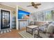 Inviting screened porch with comfortable seating, ceiling fan, and a mounted television at 1179 Holly Bend Dr, Mount Pleasant, SC 29466