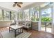 Inviting screened porch with comfortable seating and large windows with views of the outdoors at 1179 Holly Bend Dr, Mount Pleasant, SC 29466