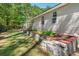 A spacious backyard is shown with a raised garden and greenhouse, perfect for gardening enthusiasts at 1227 Ocean View Rd, Charleston, SC 29412