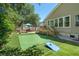 Spacious backyard with a putting green, patio set, landscaping, and well-maintained lawn at 1227 Ocean View Rd, Charleston, SC 29412