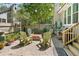 A charming backyard patio with pavers, four chairs around a fire pit, with a grill and a wooden fence at 1227 Ocean View Rd, Charleston, SC 29412