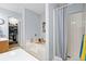 Well-lit bathroom with a soaking tub, a shower, and a walk-in closet with ample storage space at 1227 Ocean View Rd, Charleston, SC 29412