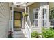 Welcoming front porch with decorative plants and a hanging flower basket by the front door at 1227 Ocean View Rd, Charleston, SC 29412