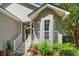 Inviting front porch with flower pots and hanging plants, enhancing curb appeal at 1227 Ocean View Rd, Charleston, SC 29412