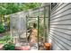 This property features a spacious, sunlit greenhouse with tables and shelving for plant care at 1227 Ocean View Rd, Charleston, SC 29412