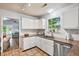 Cozy kitchen featuring white cabinets, granite countertops, and stainless steel appliances at 1227 Ocean View Rd, Charleston, SC 29412