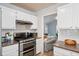 Modern kitchen with stainless steel appliances, granite countertops, and white subway tile backsplash at 1227 Ocean View Rd, Charleston, SC 29412