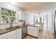 Bright kitchen with granite counters, stainless steel dishwasher, and eat-in breakfast bar at 1227 Ocean View Rd, Charleston, SC 29412