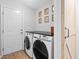Modern laundry room with front-loading washer and dryer and a barn-style sliding door at 1227 Ocean View Rd, Charleston, SC 29412