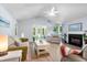 Bright living room with vaulted ceilings, a fireplace, comfortable seating, and access to outdoor spaces at 1227 Ocean View Rd, Charleston, SC 29412