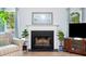 Cozy living room featuring a fireplace with mantel, plants, and natural light from nearby windows at 1227 Ocean View Rd, Charleston, SC 29412