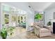 Inviting living area with a sunroom view, featuring comfortable seating and natural light at 1227 Ocean View Rd, Charleston, SC 29412
