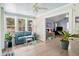Charming sunroom with ample windows, light blue ceiling, cozy seating, and access to living room at 1227 Ocean View Rd, Charleston, SC 29412
