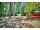 A sprawling backyard with mature trees featuring a shed, garden area, and a portion of a deck at 123 Azalea Dr, Summerville, SC 29485