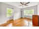 Bedroom with hardwood floors, ceiling fan, and two windows offering plenty of natural light at 123 Azalea Dr, Summerville, SC 29485