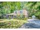 Two-story brick home boasts mature trees, driveway, and detached garage at 123 Azalea Dr, Summerville, SC 29485
