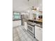 Bright kitchen with stainless steel appliances and granite counters open to the living room at 123 Azalea Dr, Summerville, SC 29485