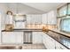 Bright kitchen with stainless steel appliances, white cabinets, and decorative backsplash at 123 Azalea Dr, Summerville, SC 29485