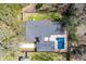 Aerial view of a home with a pool and patio, set among mature trees with fenced yard at 1235 Sunset Dr, Charleston, SC 29407