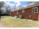 Well-maintained backyard featuring a home generator and air conditioning units at 1235 Sunset Dr, Charleston, SC 29407