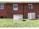 Well-maintained backyard featuring a home generator and air conditioning units at 1235 Sunset Dr, Charleston, SC 29407