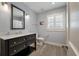 Renovated bathroom features blue walls, a large mirror, and a single vanity with marble countertop at 1235 Sunset Dr, Charleston, SC 29407