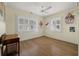 Bedroom filled with natural light includes plantation shutters, wood floors, and wall decorations at 1235 Sunset Dr, Charleston, SC 29407