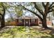 Charming brick home with mature trees, a manicured lawn, and a welcoming entrance at 1235 Sunset Dr, Charleston, SC 29407