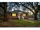 Charming brick home featuring a well-manicured lawn, mature trees, and inviting front porch at 1235 Sunset Dr, Charleston, SC 29407